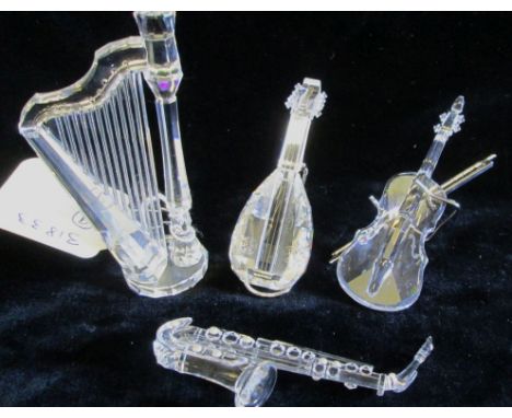 A collection of Swarovski Crystal Melodies, including Harp, Lute with stand, Saxophone and Violin with bow and stand