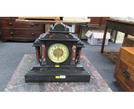 A Victorian black slate mantel clock, with rouge marble pillars and eight-day gong striking movement