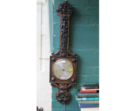 West, The Strand, a principally Victorian oak barometer, the trunk applied with Elizabethan style figural plaque over silvere