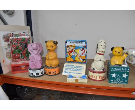 SIX ROYAL NATIONAL INSTITUTE FOR THE BLIND VINTAGE CHARITY COLLECTION POTS, DARTS, AND A PRINT comprising three papier-mâché 