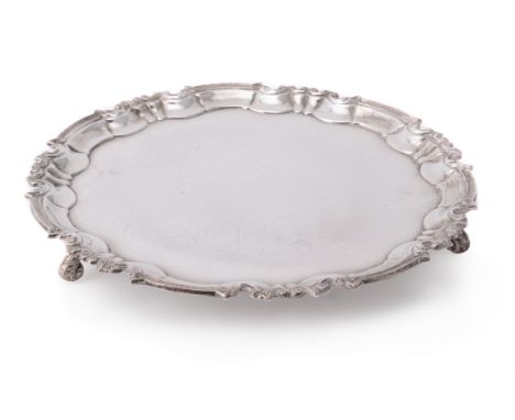 A silver shaped circular salver by William Hutton & Sons Ltd., Sheffield 1917, with a raised moulded border and on three foli