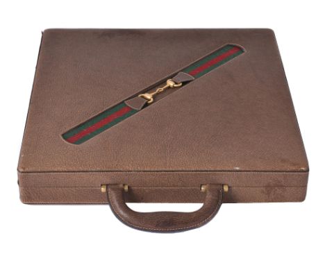 Gucci, a leather travelling back gammon, chequers, and chess set, with a loop handle and two flip lock clasps, opening to a a