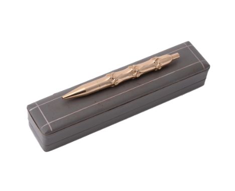 Van Cleef & Arpels, a gold coloured bamboo ball point pen, stamped 14KT, 24g gross, accompanied by a Van Cleef & Arpels boxCo