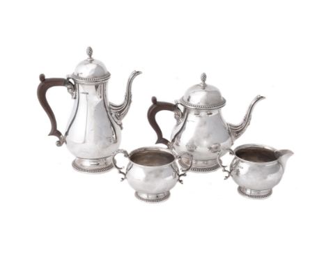 A silver baluster four piece coffee set by Walker and Hall, Birmingham 1965 (3) and 1966 (1), the coffee pot with a cone fini