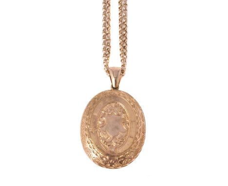 A late Victorian gold coloured locket, circa 1900, the oval hinged  locket with foliate decoration, unmarked, on a belcher li