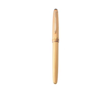 Montblanc, Meisterstuck Solitaire, a gold plated and engine turned fountain pen, the cap with a clip and cap band, the nib st