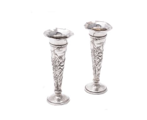 A pair of Art Nouveau silver tapering vases by William Comyns & Sons, London 1904, embossed with irises, on circular spreadin