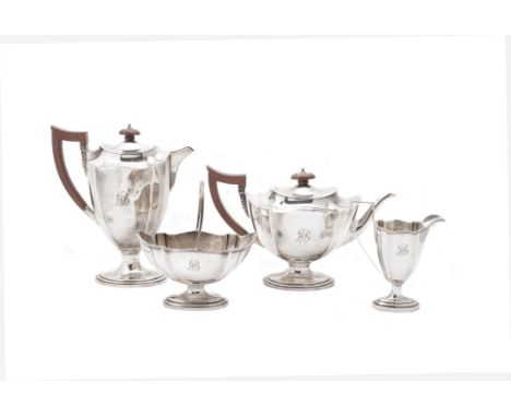 A silver shaped oval four piece tea set by Mappin & Webb, Sheffield 1948, the tea pot with a composition finial and harp hand