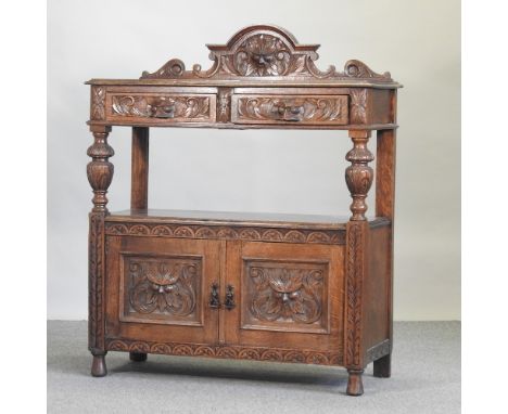 An early 20th century carved oak buffet, 106cm