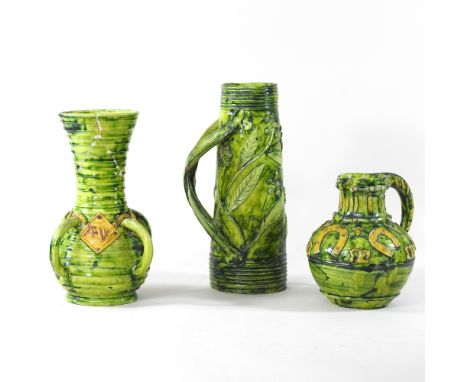 A Castle Hedingham green glazed pottery jug, with leaf and berry design, and twisted handle, 27cm high, together with a vase 