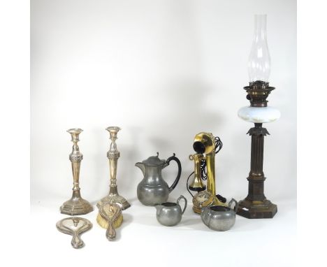 A pair of silver plated candlesticks, together with an oil lamp, a pewter part tea service, a phone and a silver backed dress