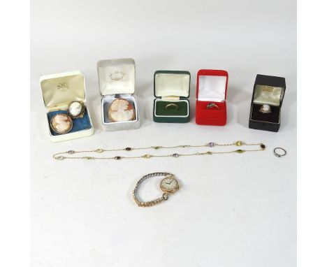 A 9 carat gold mounted cameo brooch, two others, an 18 carat textured gold band, 1.5g, size P, boxed, a 9 carat cameo ring, a