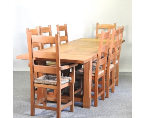 A modern light oak dining table, with two additional leaves, 282 x 90cm, together with eight rush seated chairs, to include t