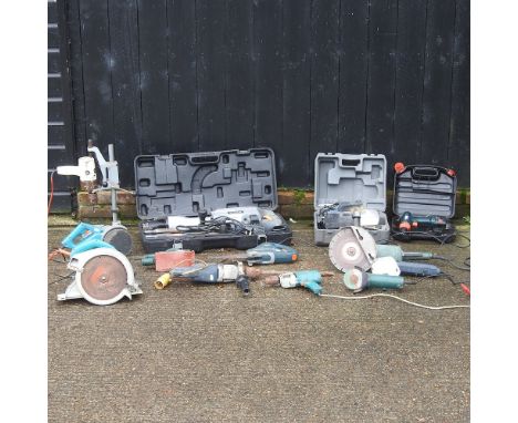 A collection of power tools, to include a Titan electric jack hammer, various drills and grinders etc