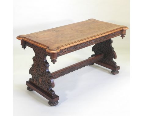 A 19th century walnut and cut card marquetry library table, on standard end supports, with ornate blind fret carved decoratio