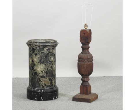 A green painted wooden simulated marble pedestal, 60cm high, together with a newel post table lamp