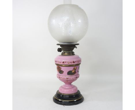 A 19th century oil lamp, with a pink opaline reservoir, and an etched glass shade, 55cm high overall