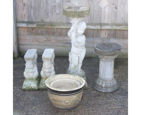 A reconstituted stone figural bird bath, 88cm high, together with a sundial, two garden pots, and a pair of bench supports (6