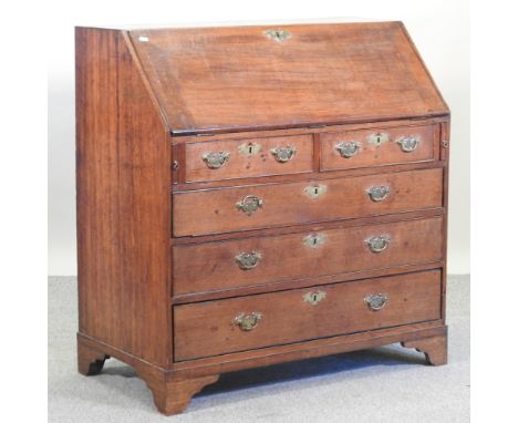 A George III oak bureau, on bracket feet, 102cm