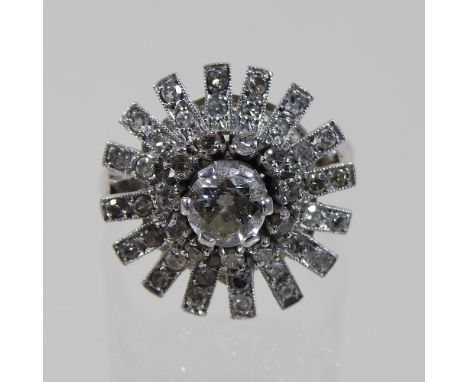 An unmarked diamond cluster ring, of star shape, size N, 6.8g gross, approximately 20mm diameter, boxed