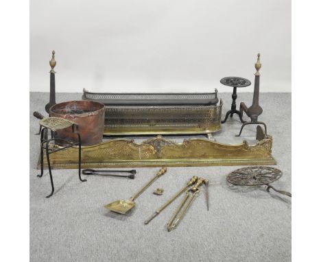 An ornate brass fender, 159cm, together with two others smaller, a pair of fire dogs, fire tools, and other metalwares