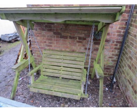 A wooden garden swinging bench 