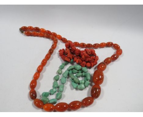Two vintage necklaces one being a free form coral style example together with a set of amber effect plastic beads (3) 