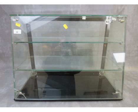 A PLATE GLASS TWO SHELF SHOP DISPLAY CABINET WITH SLOPING FRONT, sliding doors to back, H 46 cm, W 60 cm, D at base 31 cm, D 