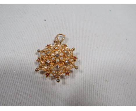 A late Victorian early 20th century 15ct pendant incrusted with seed pearls, diamonds and ruby approx. weight 6.4g Dia 3cm