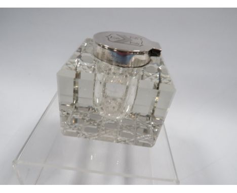 A hallmarked silver mounted cut glass inkwell with armorial 