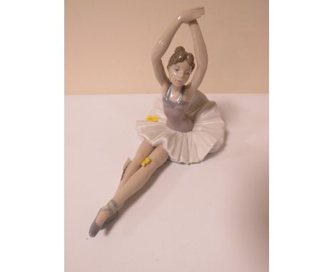 A Nao figurine of a seated ballerina 