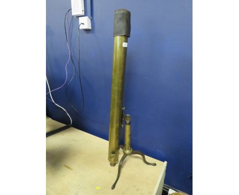 An antique brass telescope on brass tripod base 