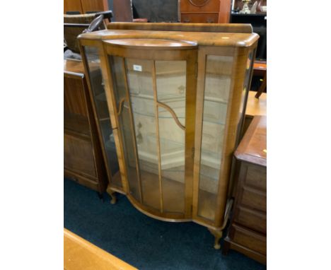 A vintage walnut china cabinet 