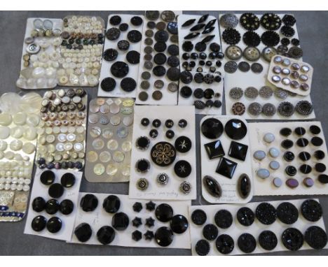 A TIN CONTAINING A COLLECTION OF ASSORTED CARDED VINTAGE BUTTONS, to include mainly jet and mother of pearl examples etc., pl