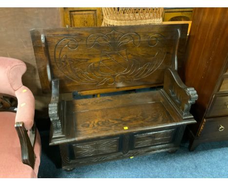 A carved oak early 20th century monks bench W 106 cm 