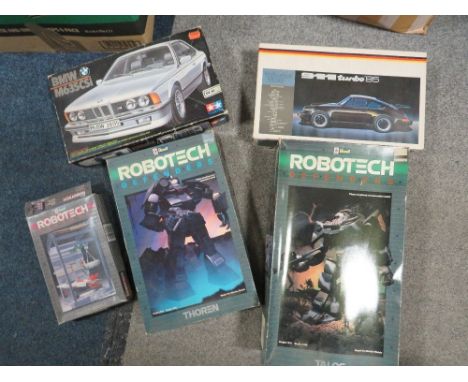 Three boxed Revel model kits to include 1:48 scale Robotech defenders, 1:72 scale Robotech defenders, 1:70 scale Robotech def