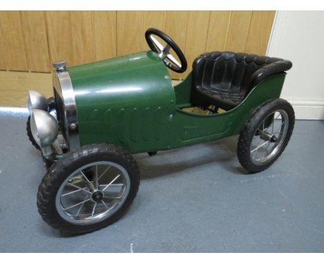 A childrens green vintage style Roadster pedal car 