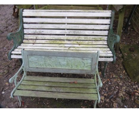 A cast iron and wooden garden bench with a smaller example 