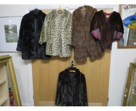 A selection of vintage fur coats to include a ladies sheepskin jacket, a vintage dress and a suit
