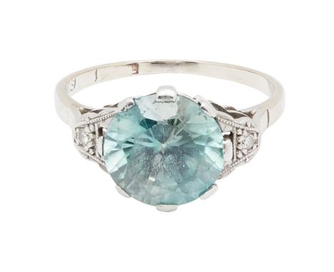 A zircon and diamond set ringclaw set with a round brilliant-cut blue zircon, each shoulder set with a small eight-cut diamon