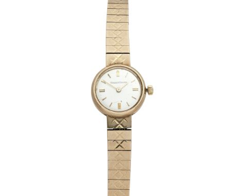 A lady's 9ct gold wrist watch, Jaeger LeCoultrechampagne dial, baton numerals, block link integral bracelet with bright cut e