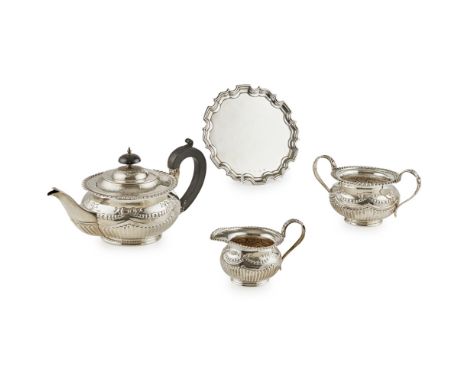 A three piece bachelors tea serviceDeakin and Sons, Sheffield 1919, of squat round form, gadroon and engraved borders, emboss
