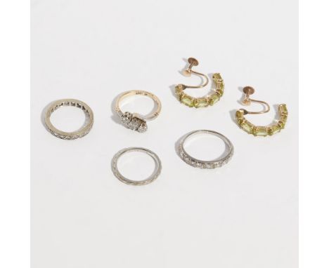 A collection of gem set jewelleryto include a three stone diamond ring, a diamond set half-eternity ring, an imitation diamon