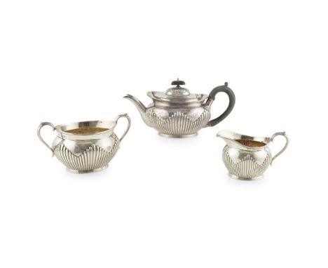 A Victorian three piece tea serviceFH, London 1881, comprising a teapot, sugar bowl and cream jug, of oval form, demi ribbed 