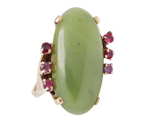 A jade and ruby set cocktail ringclaw set diagonally with a jade cabochon, set to either side with three small round-cut rubi