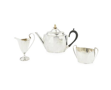 A matched three piece tea serviceRogers and Belks, Sheffield 1919, of panelled form plain, moulded scroll handles, cream jug 