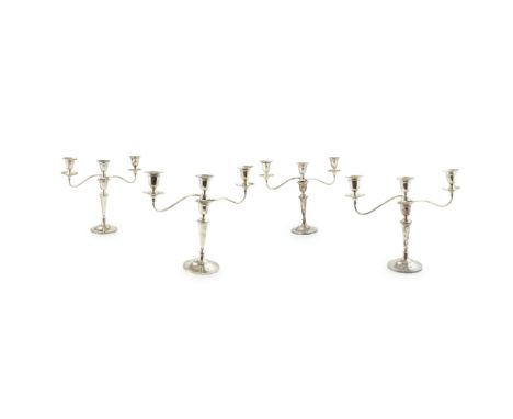 A set of four three-light table candelabraParkin and Co. Sheffield 1961, of plain form, the removable branches with scrolled 