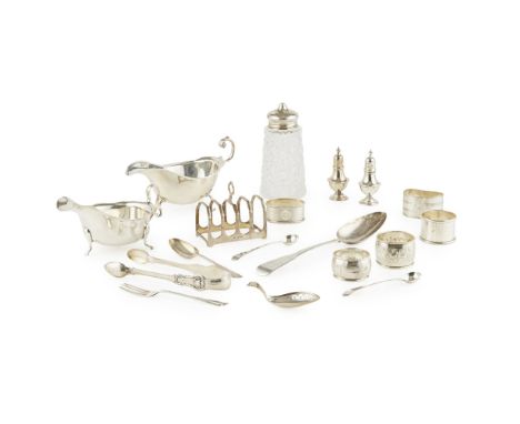 A group of small silver to includetwo sauce boats, toast rack, glass and silver mounted sugar caster, napkin rings, some odd 