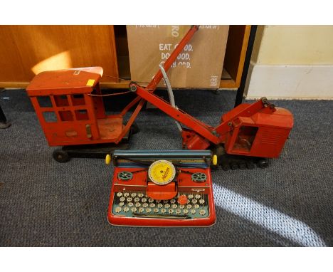 Tinplate:&nbsp;a vintage tinplate Mettoy Junior typewriter; together with two tinplate Triang cranes. (3) 