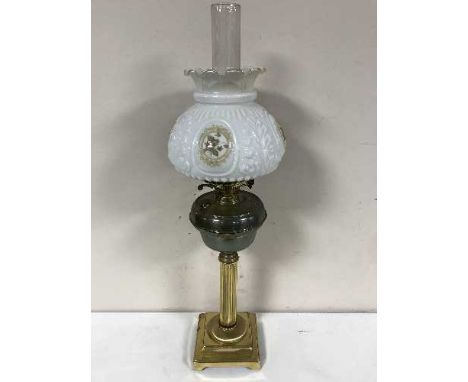 An antique brass oil lamp with brass shade and chimney 